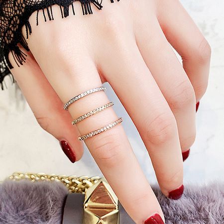 A model's hand showcasing the stackable nature of the 925 sterling silver CZ eternity rings.