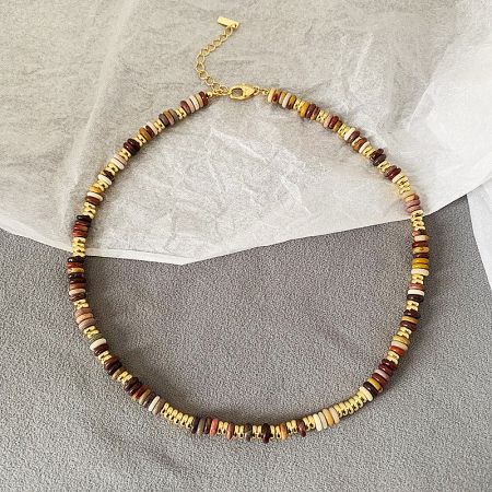 A brown-toned beaded necklace from the set, showcasing its handmade quality.