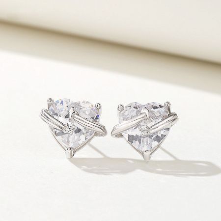Detailed view of the heart-shaped zircon stud earrings, emphasizing the clear gemstones.