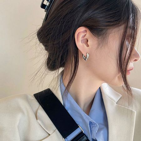 A model showcasing the elegant V-shape hoop earrings, highlighting their stylish appeal.