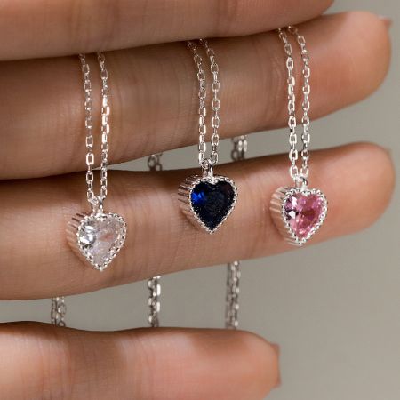 925 Sterling Silver Heart Necklace Set with CZ Pave Pendants - A collection of three 925 sterling silver heart necklaces featuring clear, blue, and pink CZ pave gemstones, displayed on a white background.