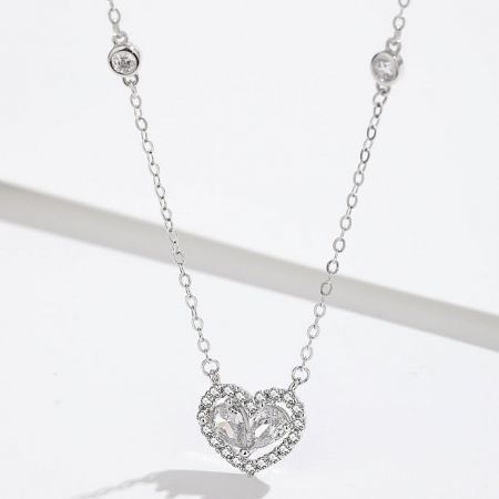 The sterling silver heart necklace with a pendant made of clear, brilliant crystals.