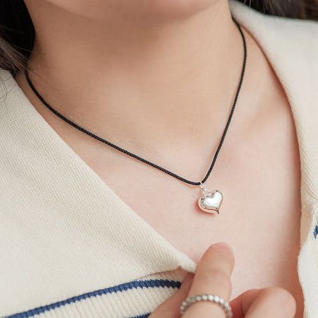 Lifestyle shot showcasing the heart pendant necklace.