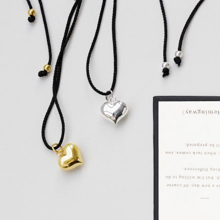 Multiple heart-shaped pendant necklaces displayed together.