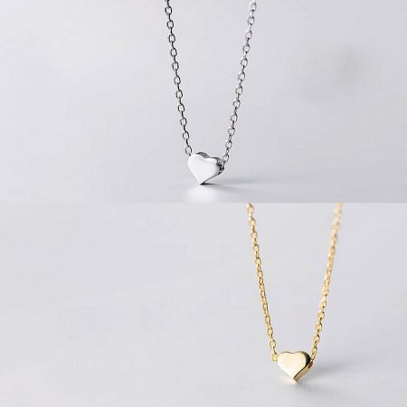 Elegant presentation of the silver and gold heart pendant necklaces.