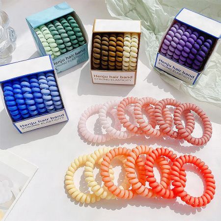 Spiral hair ties in packaging, available in multiple colors.
