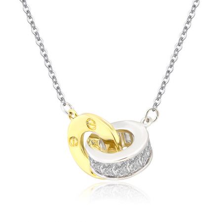 Detailed shot of the interlocking gold and silver pendant design of the CZ necklace.