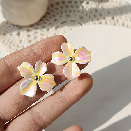 Angled view of the iridescent flower earrings showcasing their colorful sheen.
