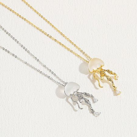 Top-down view of the gold and silver jellyfish necklaces, highlighting their intricate design.
