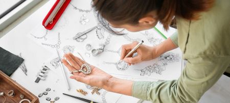 Jewelry designer sketching custom designs for OEM/ODM production at JR Fashion Accessories.