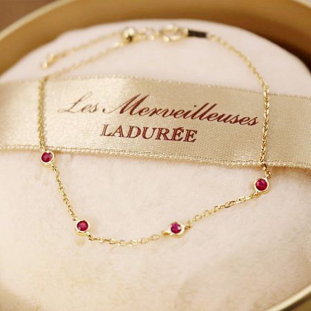 The ruby link chain bracelet presented in a stylish context, perfect for gifting.