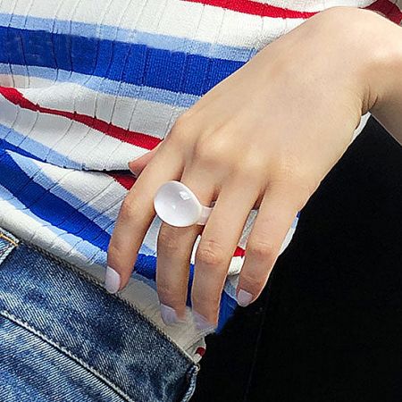 The elegant large white glass dome ring, a statement piece of fashion jewelry.