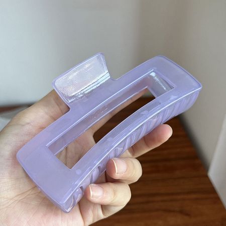 A lavender purple rectangle hair clip with a unique side pattern.