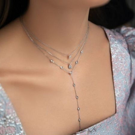 The layered sterling silver necklace set with clear stones, demonstrating its versatility for special occasions.