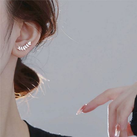 A model showcasing the unique leaf-shaped earring, highlighting its elegant design on the ear.
