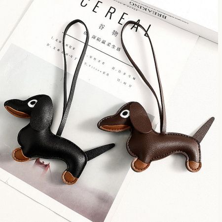 Plush Leather Dachshund Dog Bag Charms (Set of 5) - A set of two PU leather dachshund dog bag charms, one black and one brown, displayed side-by-side with their attachment straps.