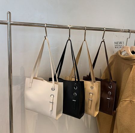 Collection of customizable leather handbags available in various colors.