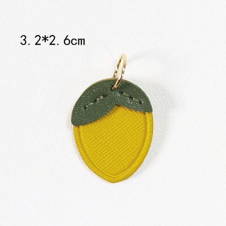 A bright yellow lemon-shaped PU leather charm