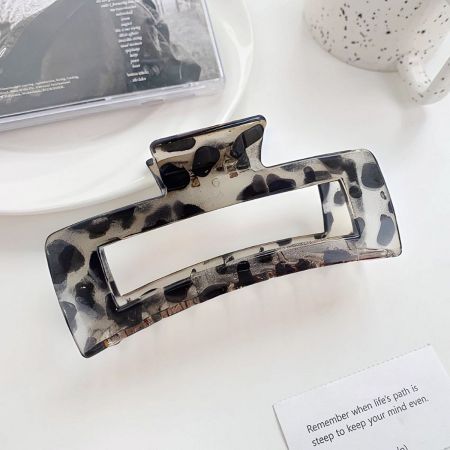 Side view of a large leopard print acetate hair claw clip.