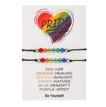 A collection of LGBTQ+ pride bracelets, including the rainbow rope design, displayed with a 'Love is love' heart.