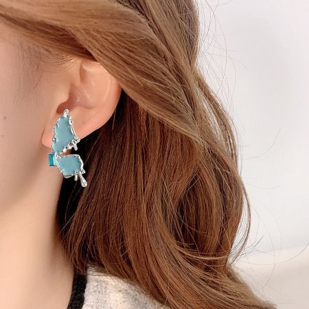 Detailed view of the light blue enamel and zircon stone on the butterfly earring.