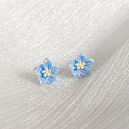 Light Blue Resin Small Floral Flower Stud Earrings (5 pairs) - A pair of light blue resin small floral flower stud earrings with white centers, shown on a clean white background.