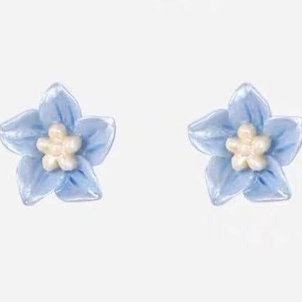 Elegant handmade blue flower studs made of S925 silver, presented as a pair.