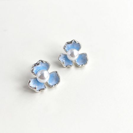 Top-down view of the silver-plated iris flower pearl stud earrings.