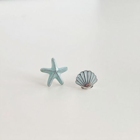 Wholesale Silver-Plated Enamel Starfish & Seashell Stud Earrings (Set of 5 Pairs) - A pair of wholesale silver-plated enamel stud earrings featuring a light blue starfish and a silver seashell on a white background.