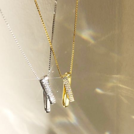 Elegant display of both silver and gold interlocking necklaces with brilliant CZ stones.