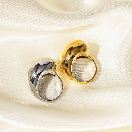 Detailed view of the drop-dripping design on both the gold and silver rings.