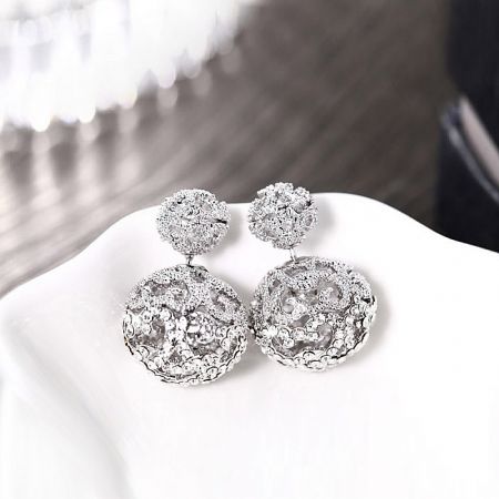 Angled shot of the Double Ball Pave Diamond earrings, capturing their luxurious and sophisticated design.