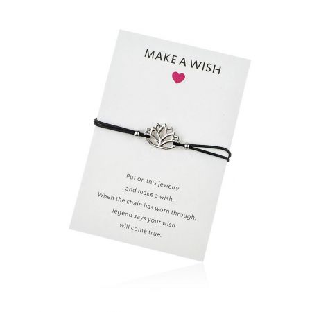 The Lotus Cord Bracelet - A close-up of the Lotus Cord Bracelet featuring a black waxed cord and a silver lotus flower charm, presented with a 'Make A Wish' card.