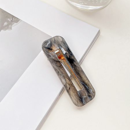 A single hair clip with a unique grey and white marbled pattern.