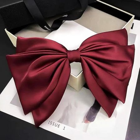 Vibrant maroon satin ribbon bow in a presentation box.