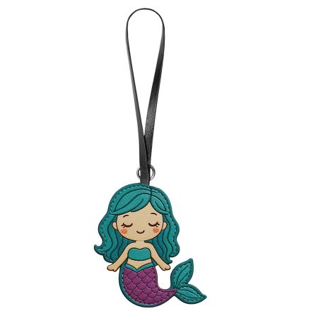 A cute cartoon-style mermaid leather bag charm with turquoise hair.