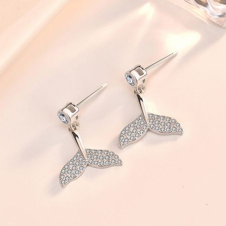 Detailed close-up of the silver mermaid tail stud earring, showcasing the brilliant CZ stones.