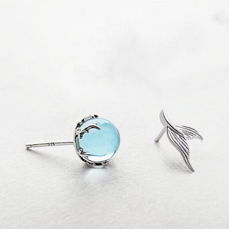 925 Sterling Silver Asymmetrical Moonstone Mermaid Fishtail Stud Earrings - A pair of asymmetrical 925 sterling silver stud earrings, one featuring a round moonstone and the other a detailed mermaid fishtail, on a clean white background.