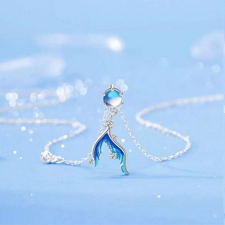 Professional product shot of the moonstone mermaid tail necklace.