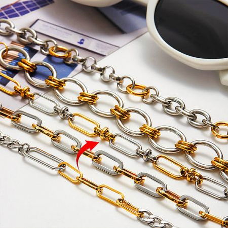 Stainless Steel Bracelets - A collection of wholesale stainless steel bracelets from JR Fashion Accessories, featuring various two-tone gold and silver chain designs.