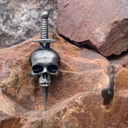 Metal skull and dagger pin from the Halloween collection.
