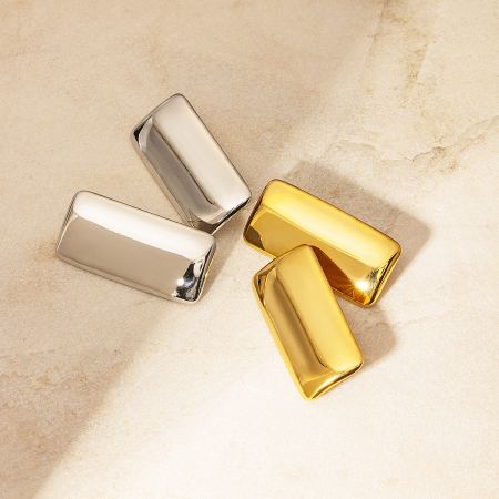A product shot displaying the geometric rectangular earrings in both silver and gold finishes.