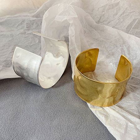 Close-up of the hammered texture on the gold and silver Egypt-style cuff bracelets.