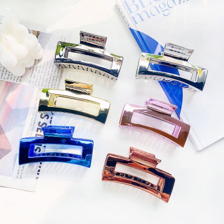 An assortment of metallic hair clips in different finishes.