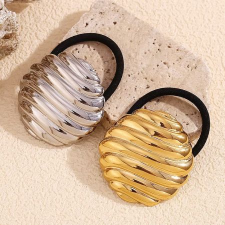 Detailed shot of the gold and silver round stripe hair ties on a white background.