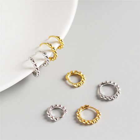 925 Sterling Silver Round Bead Hoop Earrings (Set of 5 Pairs) - A pair of 925 sterling silver round bead hoop earrings shown in both polished gold and silver finishes, highlighting their classic design.