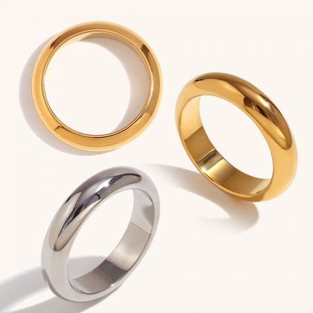 A set of three minimalist stainless steel rings in both gold and silver finishes.