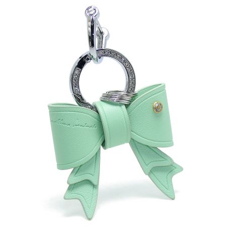 Stylish mint green PU leather bow keychain, perfect as a modern bag charm.