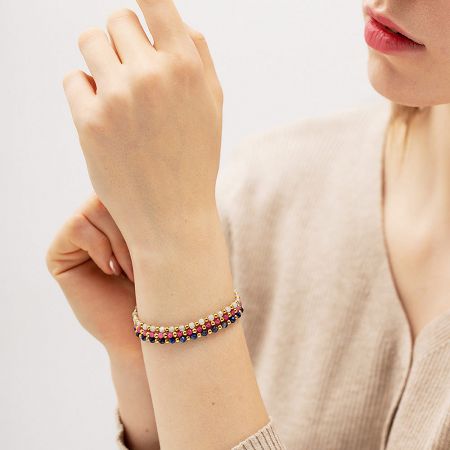 Clean product shot of a multicolored stainless steel and glass bead bracelet on a white background.