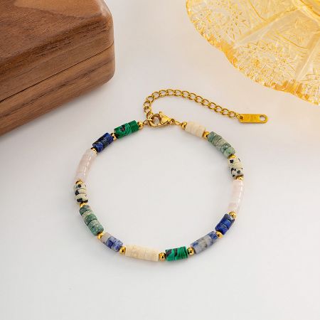 A close-up of the multicolored beaded bracelet's gold clasp and extension chain.